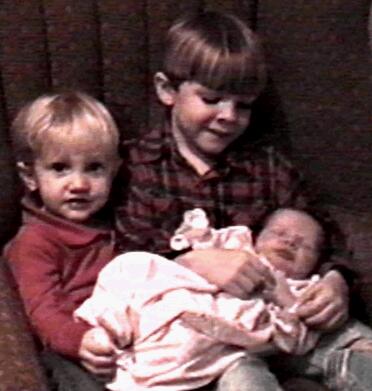 Brenden Carter Smith and Creighton Geoffrey Smith holding Regan Taylor Smith, November 25, 1996